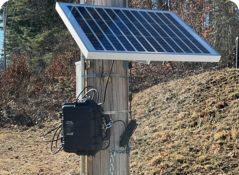 Solar panel mounted on wooden pole.